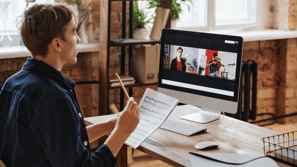 A student participates in an online music theory lesson via video call, highlighting how digital tools enhance modern music education for producers.