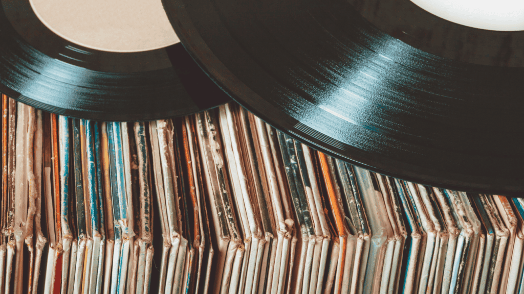 Stack of vintage vinyl records with a close-up of black vinyl discs