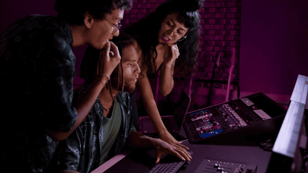 Three producers collaborating in a music studio, exploring beats on BeatsDen.