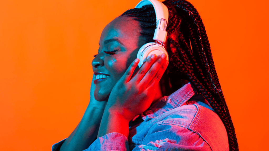 Woman smiling while listening to music on headphones.