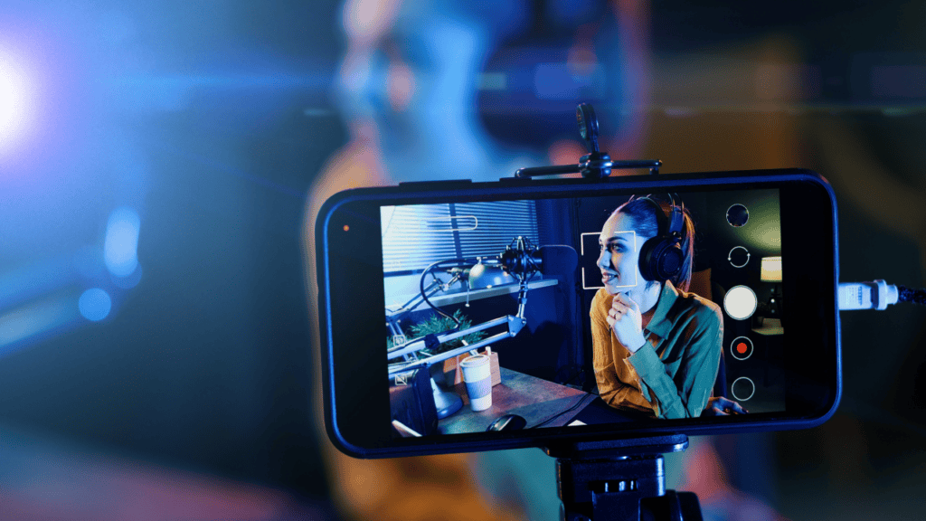 Musician live streaming with microphone and engaging with audience.