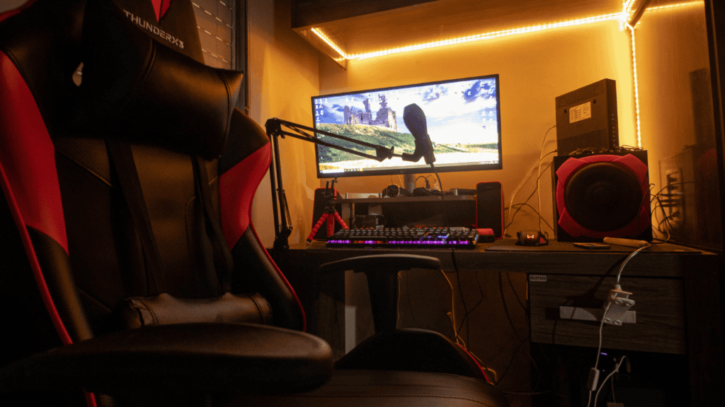 Professional gaming setup featuring a gaming chair, keyboard, and microphone.