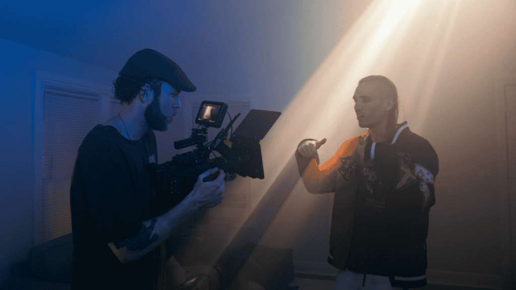 Videographer filming a rapper in a dramatic light setup