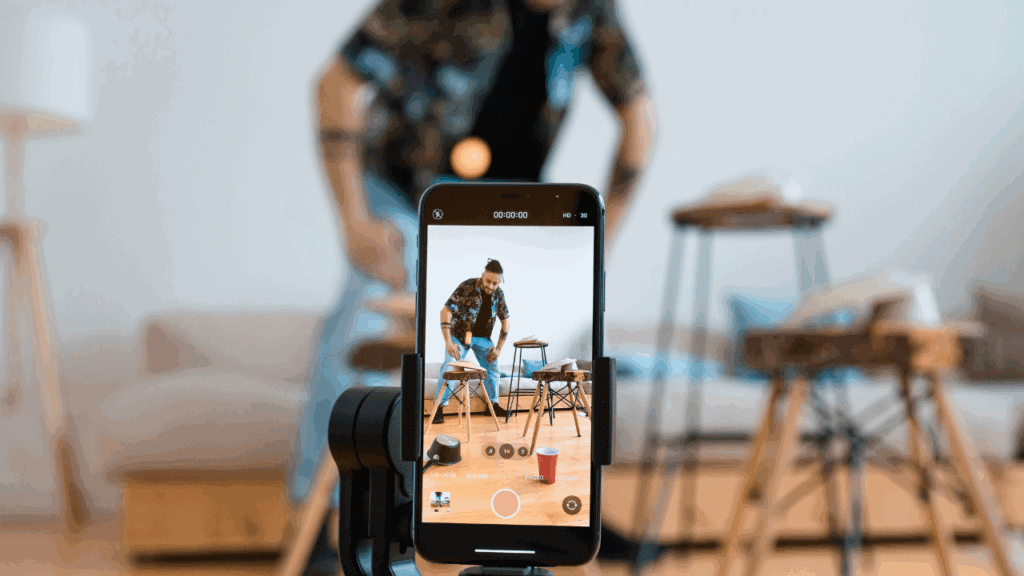 Artist filming a music performance on a smartphone for TikTok and Reels viral videos.